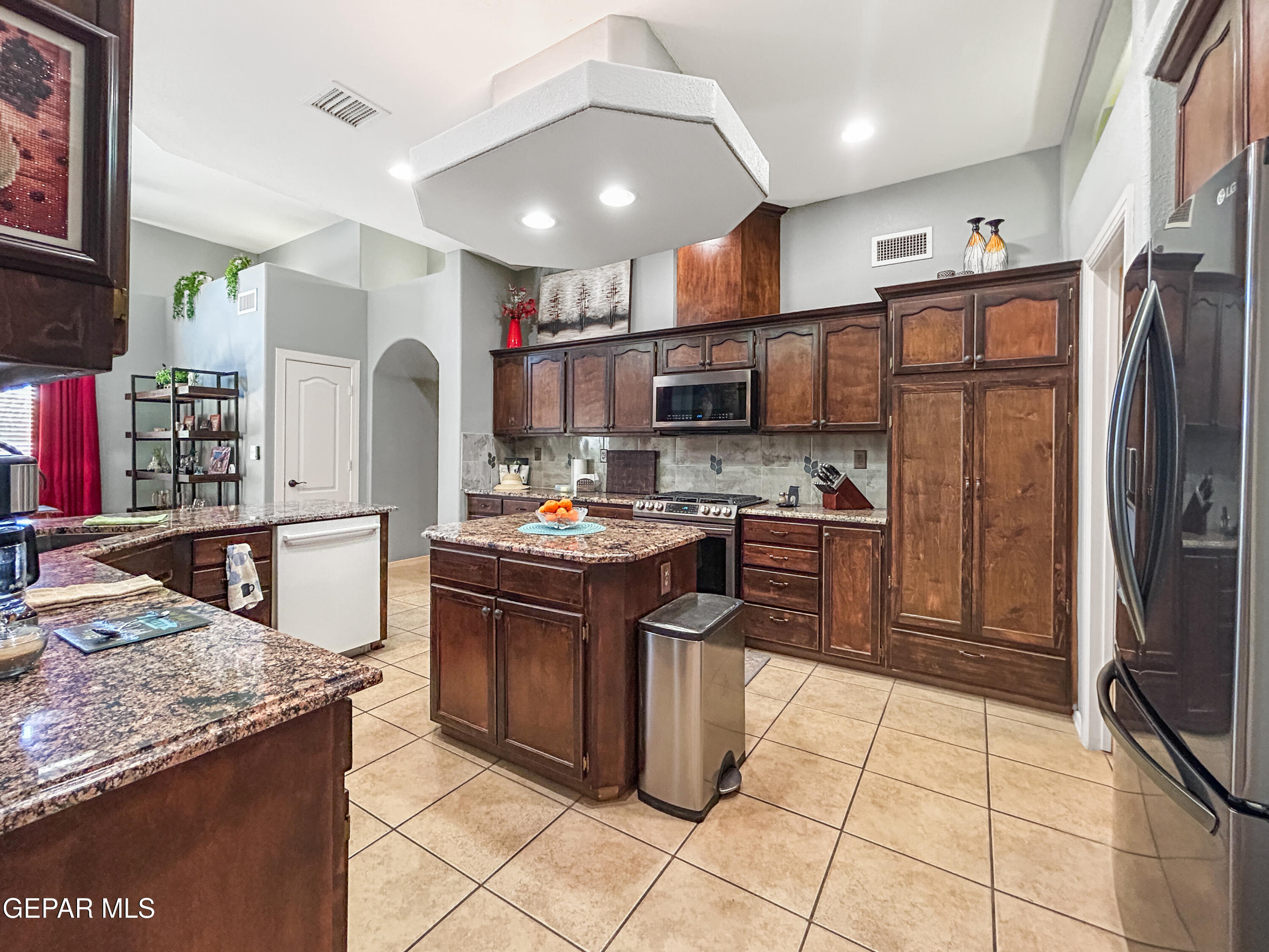 6680 Capitan Ridge El Paso, TX 79912 - Photo 5 of 47 a kitchen with stainless steel appliances granite countertop a refrigerator stove and oven