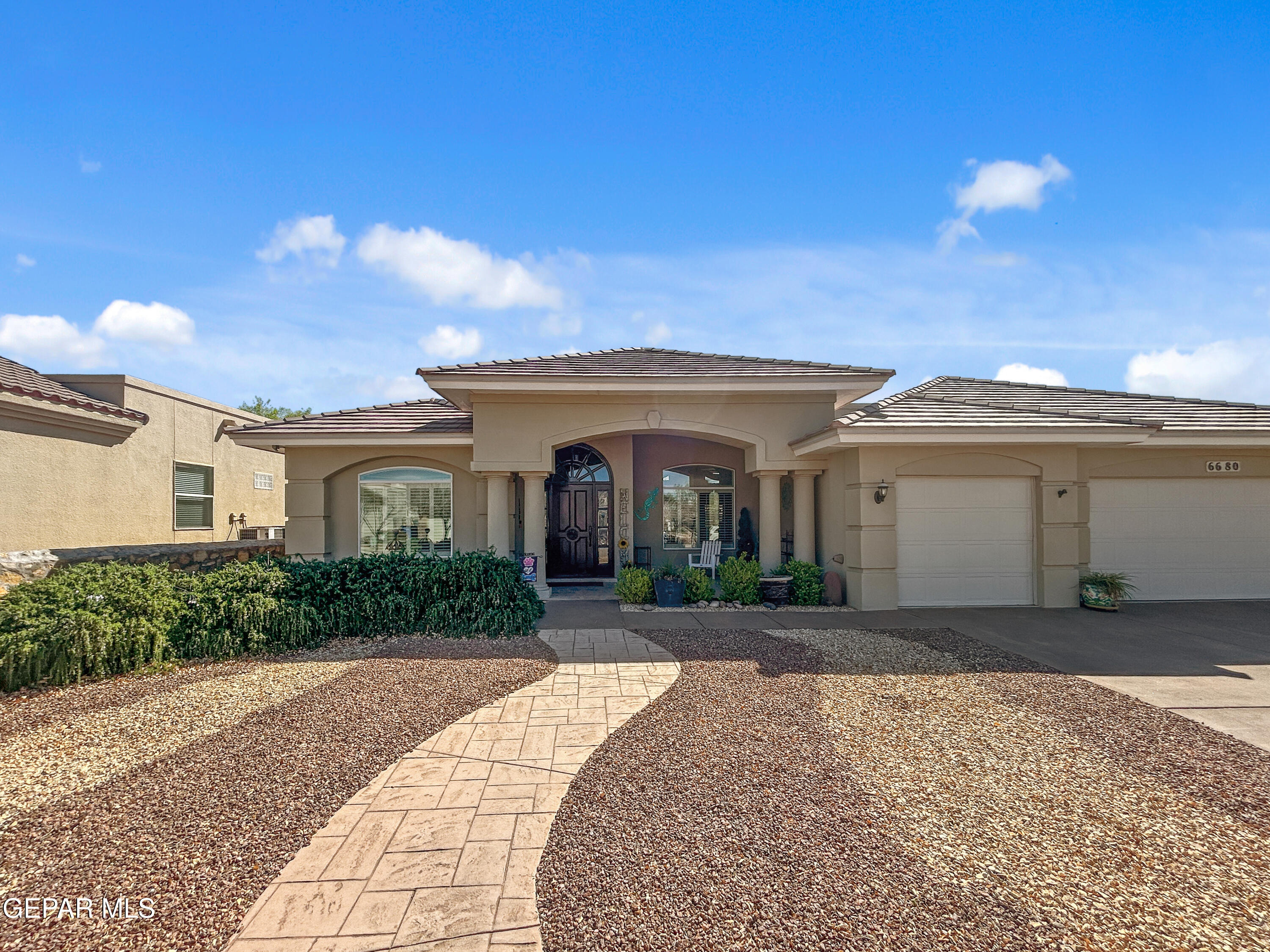 6680 Capitan Ridge El Paso, TX 79912 - Photo 8 of 47 a front view of a house with a yard and garage