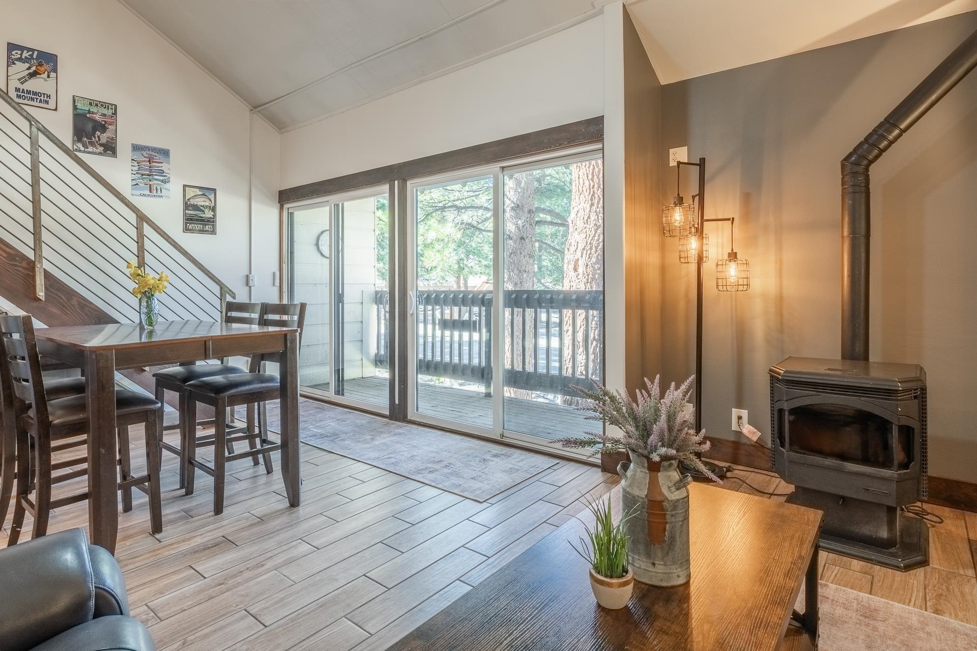 2289 Sierra Nevada Road, Unit F11 Mammoth Lakes, CA 93546 - Photo 3 of 17 a living room with furniture a fireplace and a floor to ceiling window