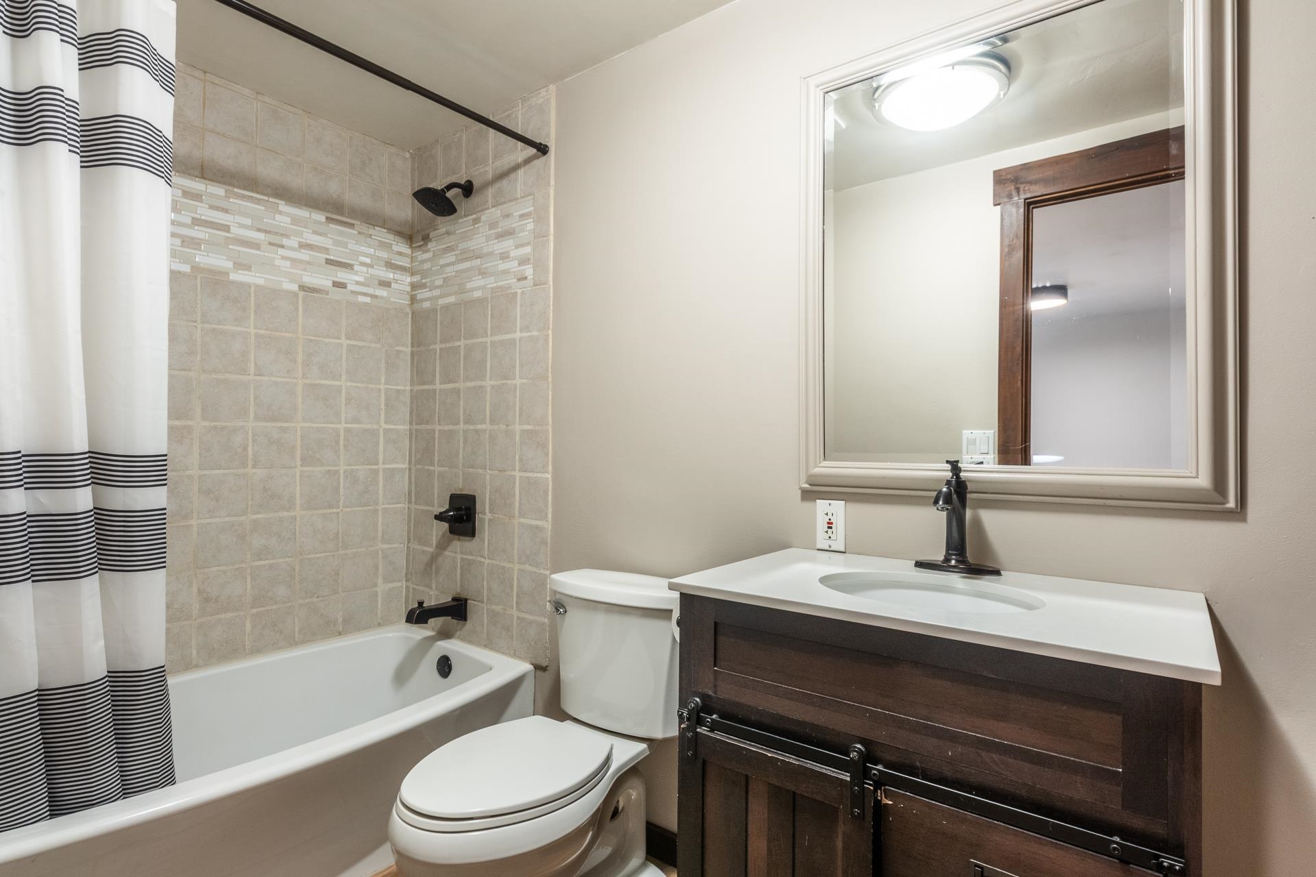 2289 Sierra Nevada Road, Unit F11 Mammoth Lakes, CA 93546 - Photo 9 of 17 a bathroom with a sink a toilet a mirror a bathtub and shower