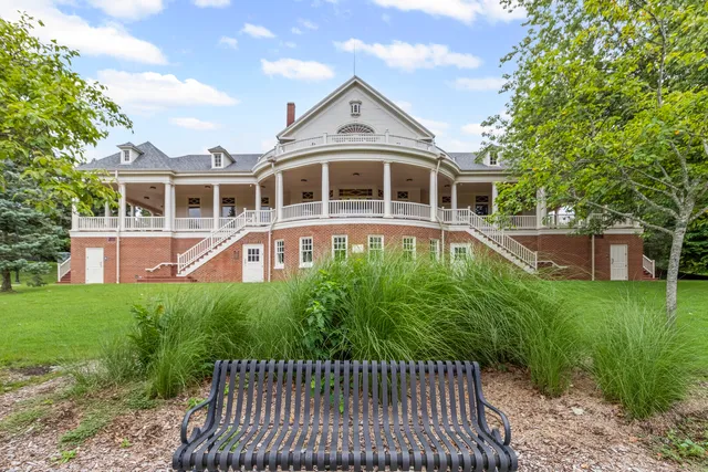 a front view of a house with a yard table and chairs