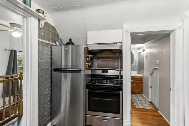 a kitchen with stainless steel appliances a refrigerator and a stove top oven