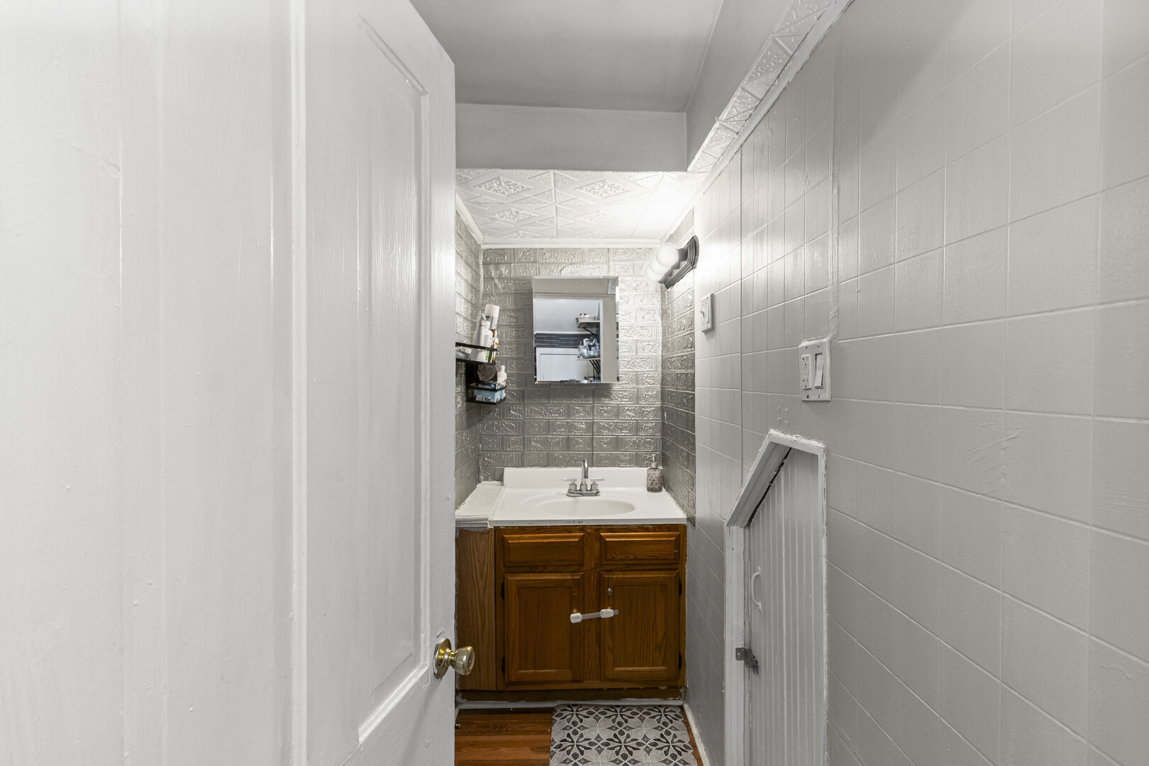 102 South Liberty Street, Unit 3 Elgin, IL 60120 - Photo 10 of 18 a bathroom with a sink and a mirror