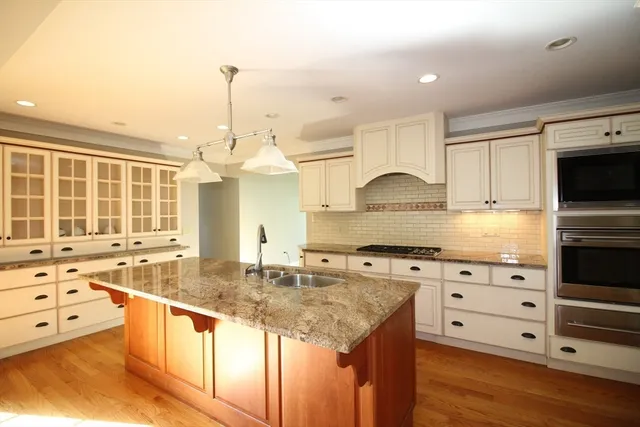a kitchen with granite countertop a stove and a sink