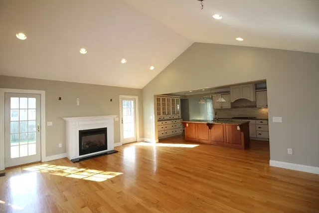 a view of livingroom with kitchen and fireplace