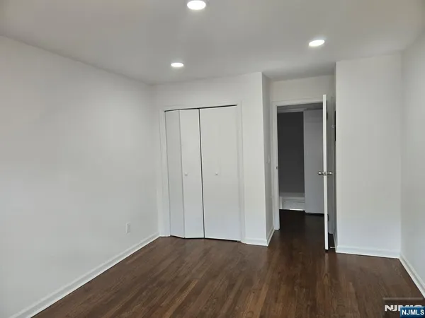 a view of an empty room and wooden floor