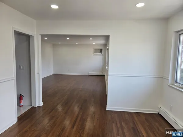 a view of a room with wooden floor