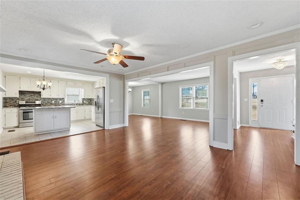 2328 Horseshoe Bend Road Southwest Marietta, GA 30064 - Photo 13 of 44 a view of an empty room with kitchen view and wooden floor