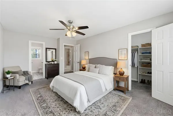 a spacious bedroom with a bed and a chandelier