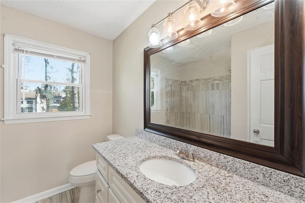 2328 Horseshoe Bend Road Southwest Marietta, GA 30064 - Photo 21 of 44 a bathroom with a granite countertop sink toilet and mirror