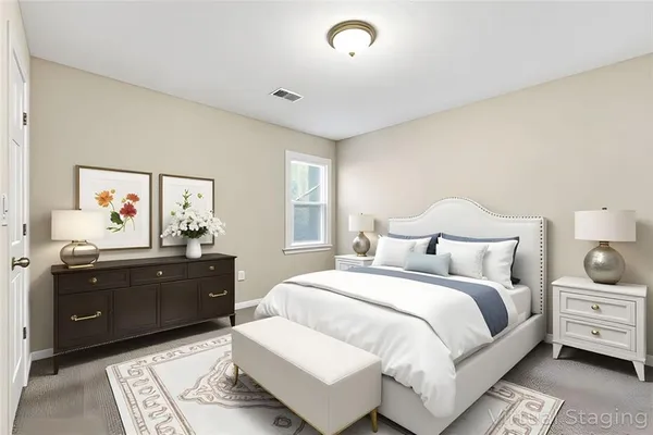 a bedroom with a bed and a dresser