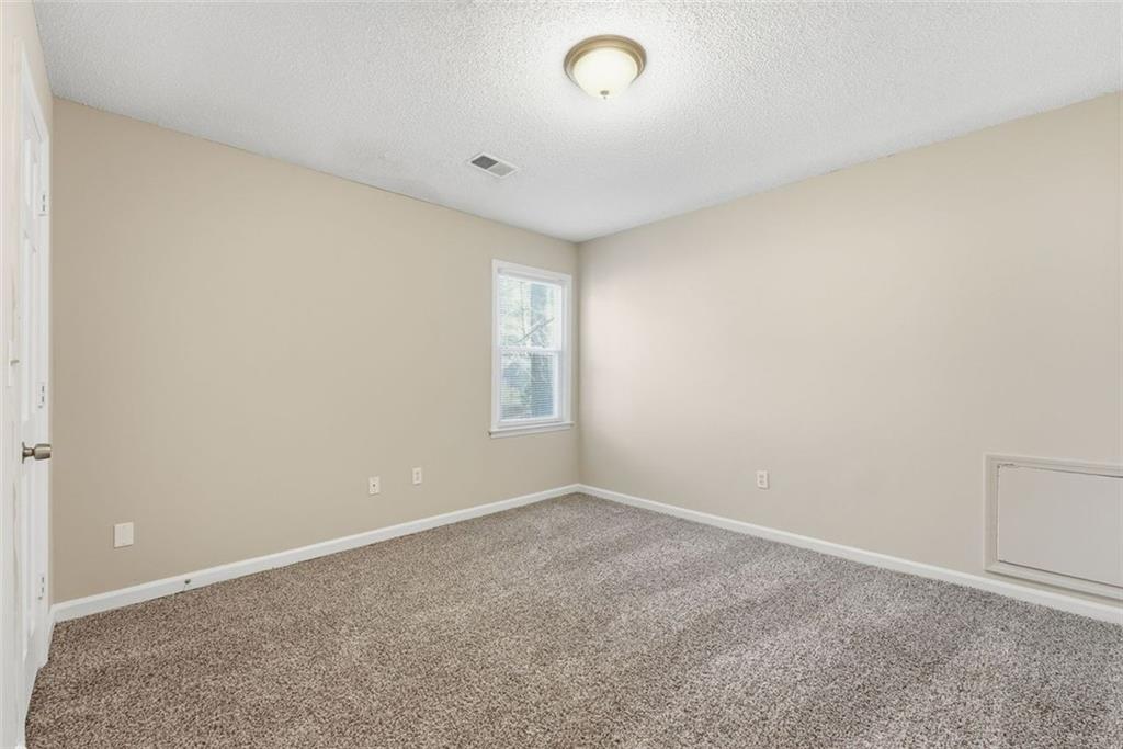 2328 Horseshoe Bend Road Southwest Marietta, GA 30064 - Photo 24 of 44 an empty room with windows