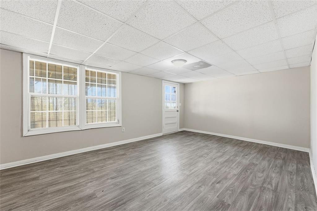 2328 Horseshoe Bend Road Southwest Marietta, GA 30064 - Photo 30 of 44 an empty room with wooden floor and windows