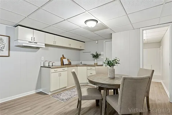 a dining room with kitchen island a table and chairs