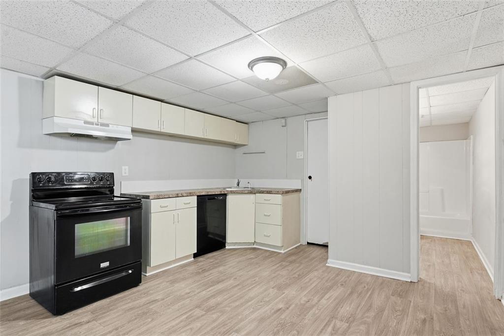 2328 Horseshoe Bend Road Southwest Marietta, GA 30064 - Photo 32 of 44 a kitchen with granite countertop a stove a microwave and wooden floors