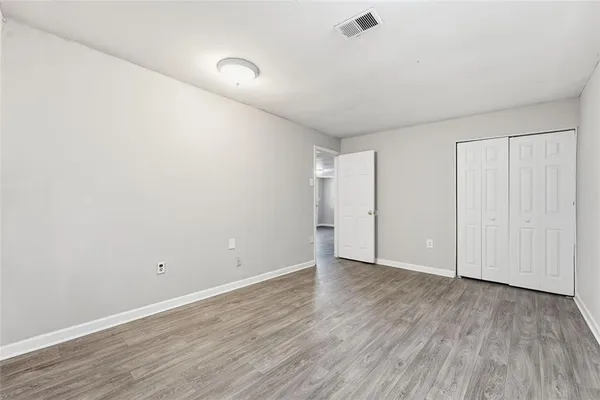 a view of an empty room with wooden floor
