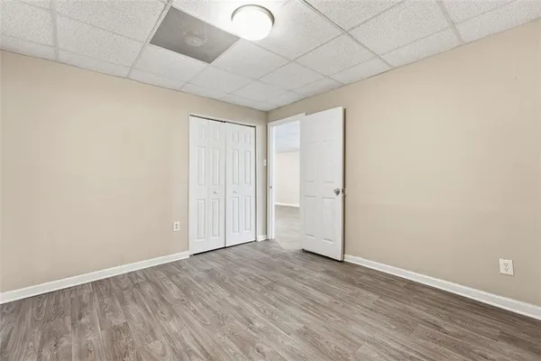a view of an empty room with wooden floor