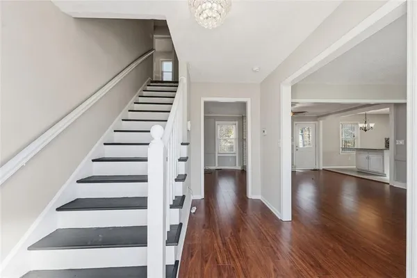 a view of an entryway with wooden floor and stairs