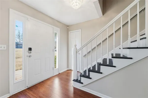 a view of staircase with wooden floor and entryway
