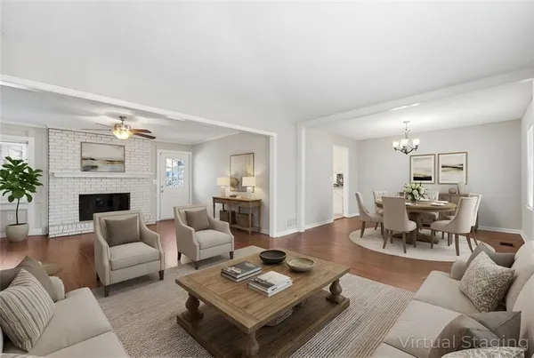 a living room with furniture a fireplace and a potted plant