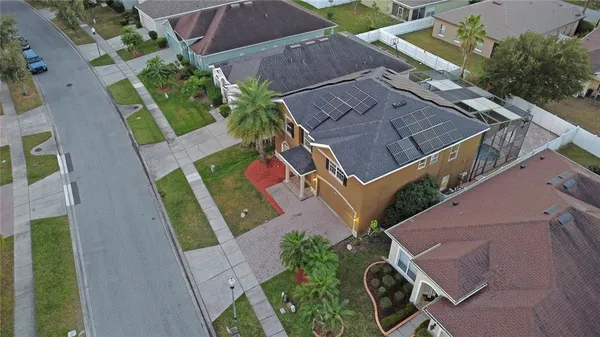 an aerial view of a house with a yard