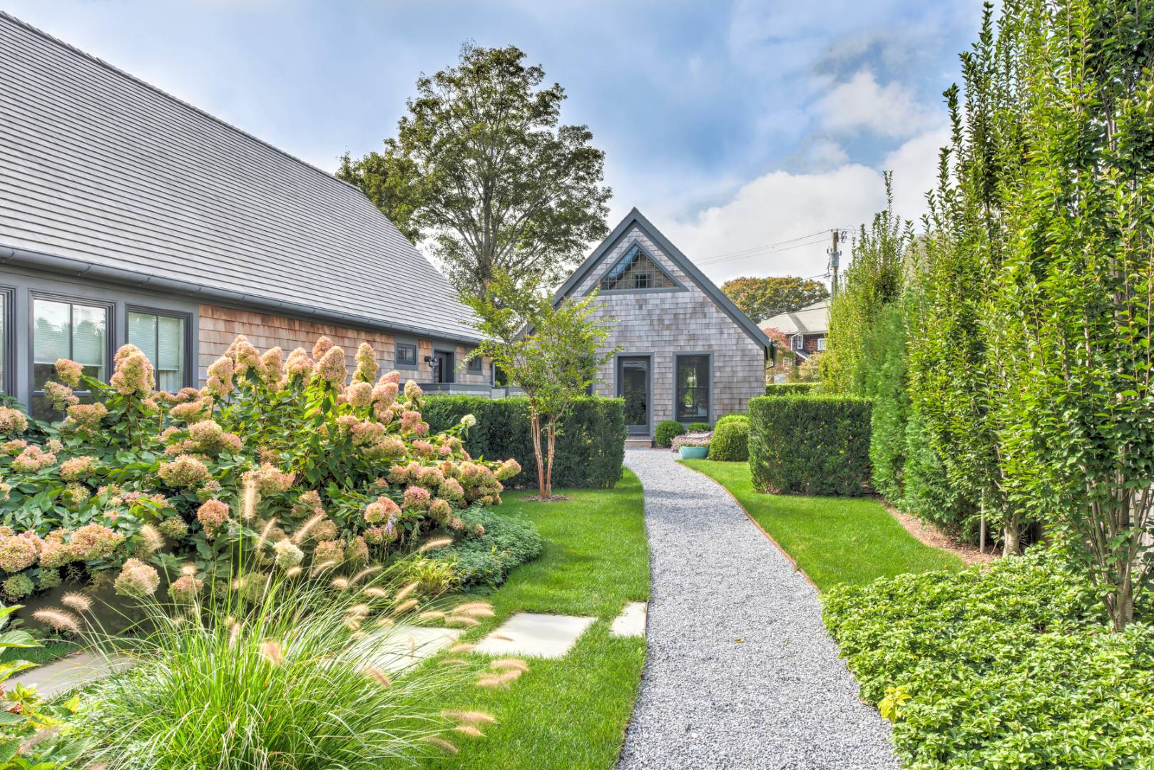 83 School Street Bridgehampton, NY 11932 - Photo 3 of 19 a front view of a house with garden