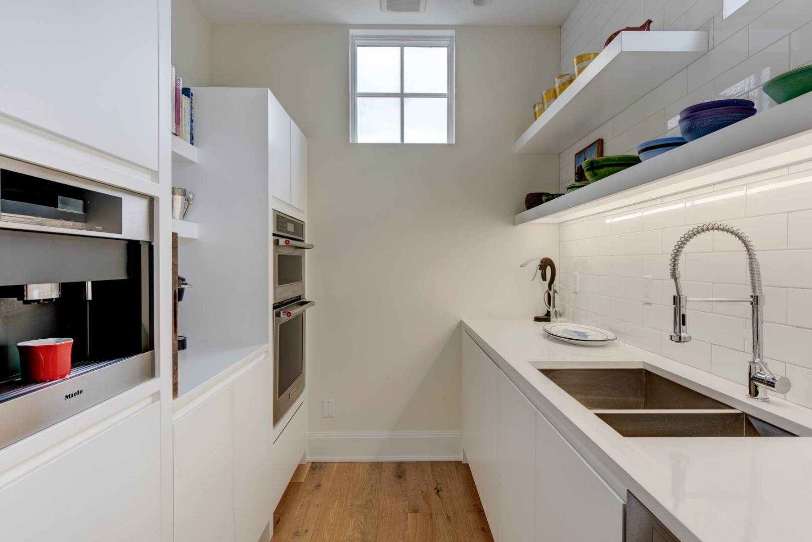 83 School Street Bridgehampton, NY 11932 - Photo 9 of 19 a kitchen with a sink and a refrigerator