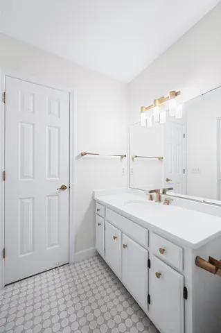 a view of a kitchen with white cabinets