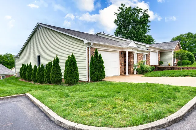 a view of a house with a backyard