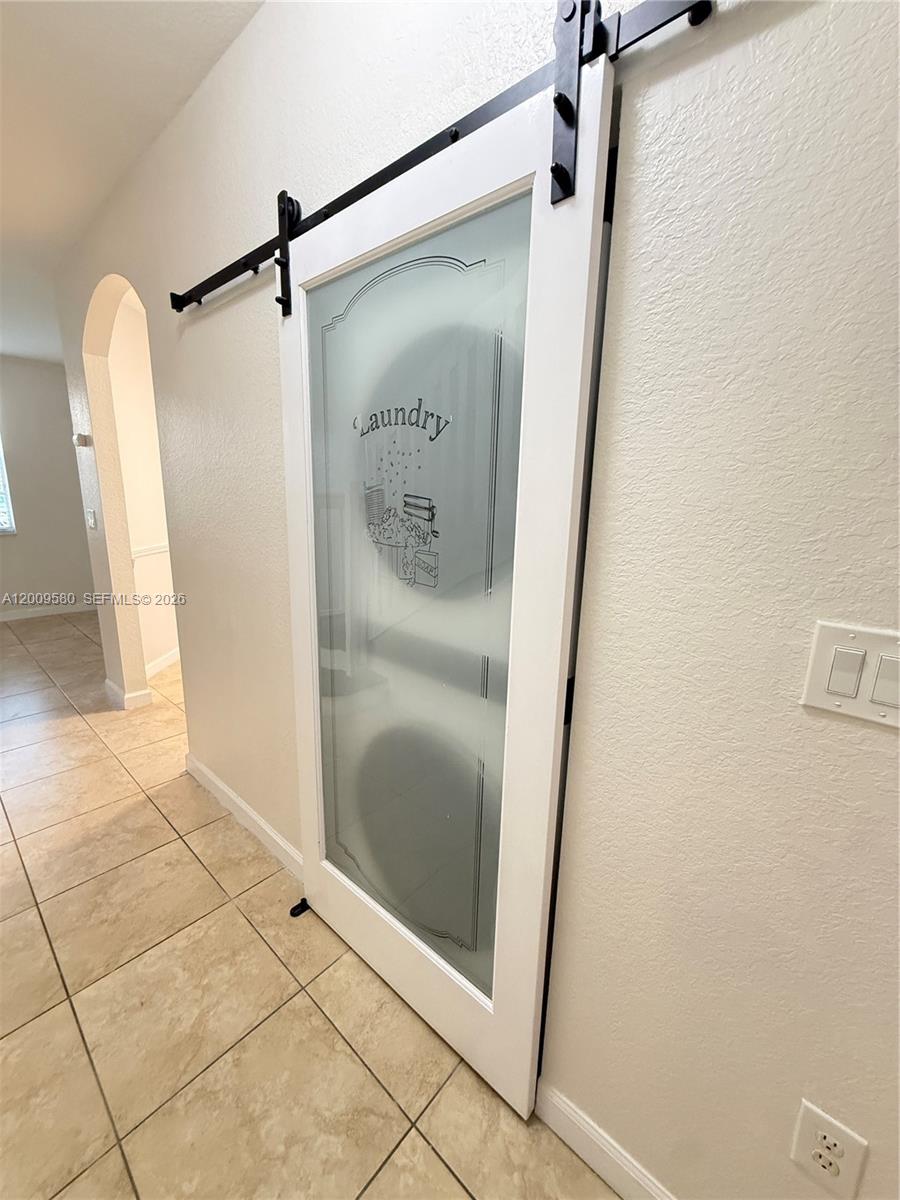 9239 Southwest 227th Street, Unit 1 Cutler Bay, FL 33190 - Photo 12 of 39 a bathroom with a glass shower door and mirror