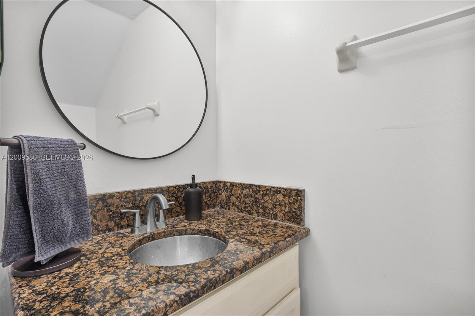 9239 Southwest 227th Street, Unit 1 Cutler Bay, FL 33190 - Photo 14 of 39 a bathroom with a granite countertop sink and a mirror