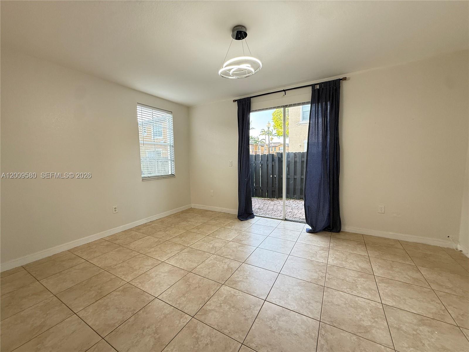 9239 Southwest 227th Street, Unit 1 Cutler Bay, FL 33190 - Photo 16 of 39 a view of an empty room with a window