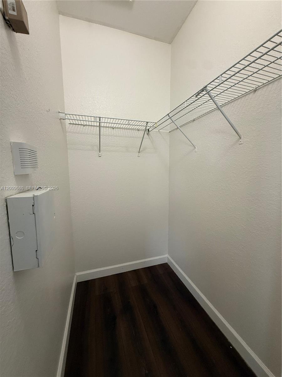 9239 Southwest 227th Street, Unit 1 Cutler Bay, FL 33190 - Photo 22 of 39 a view of a room with racks on the wall