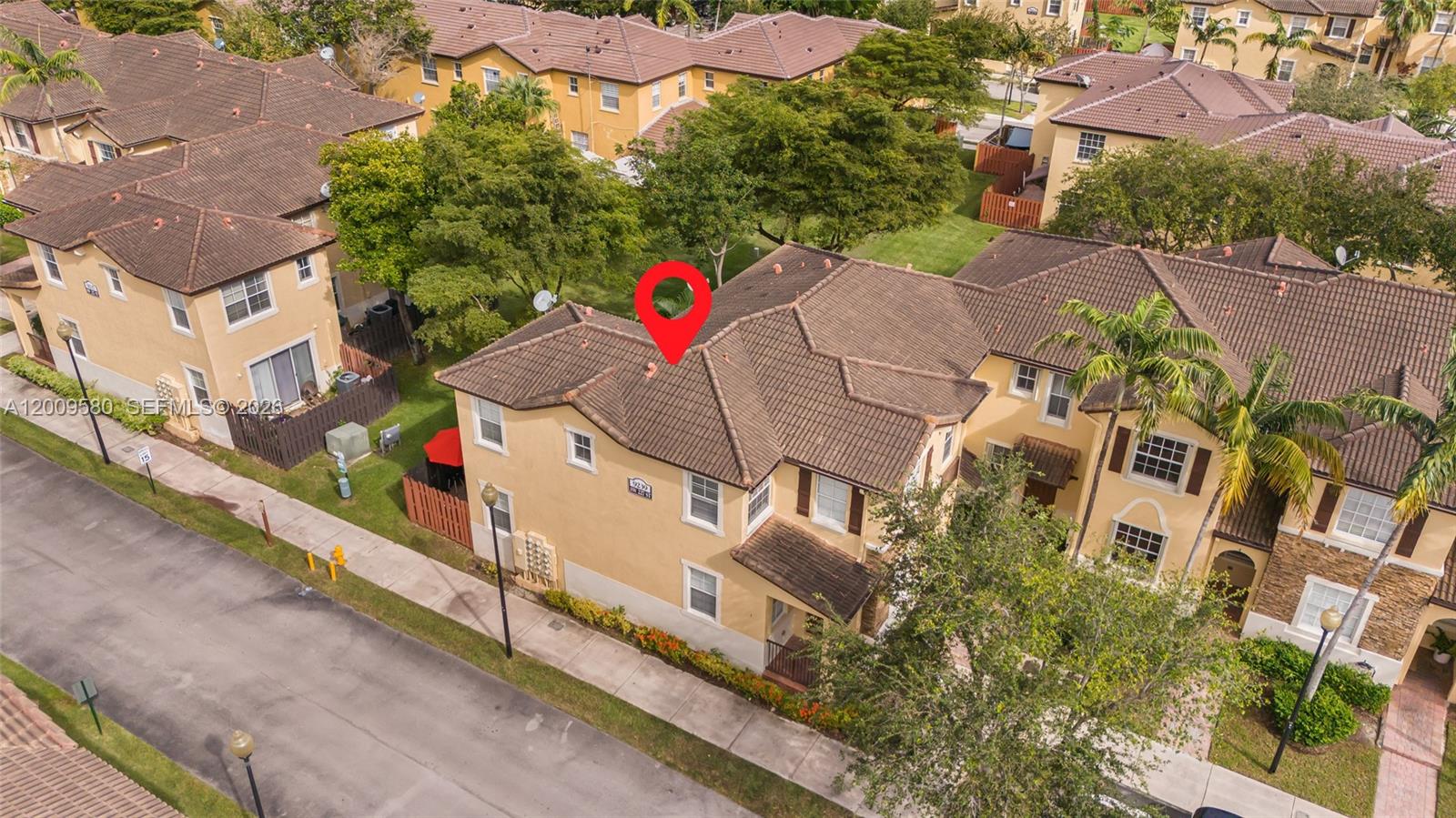 9239 Southwest 227th Street, Unit 1 Cutler Bay, FL 33190 - Photo 29 of 39 an aerial view of multiple houses with yard