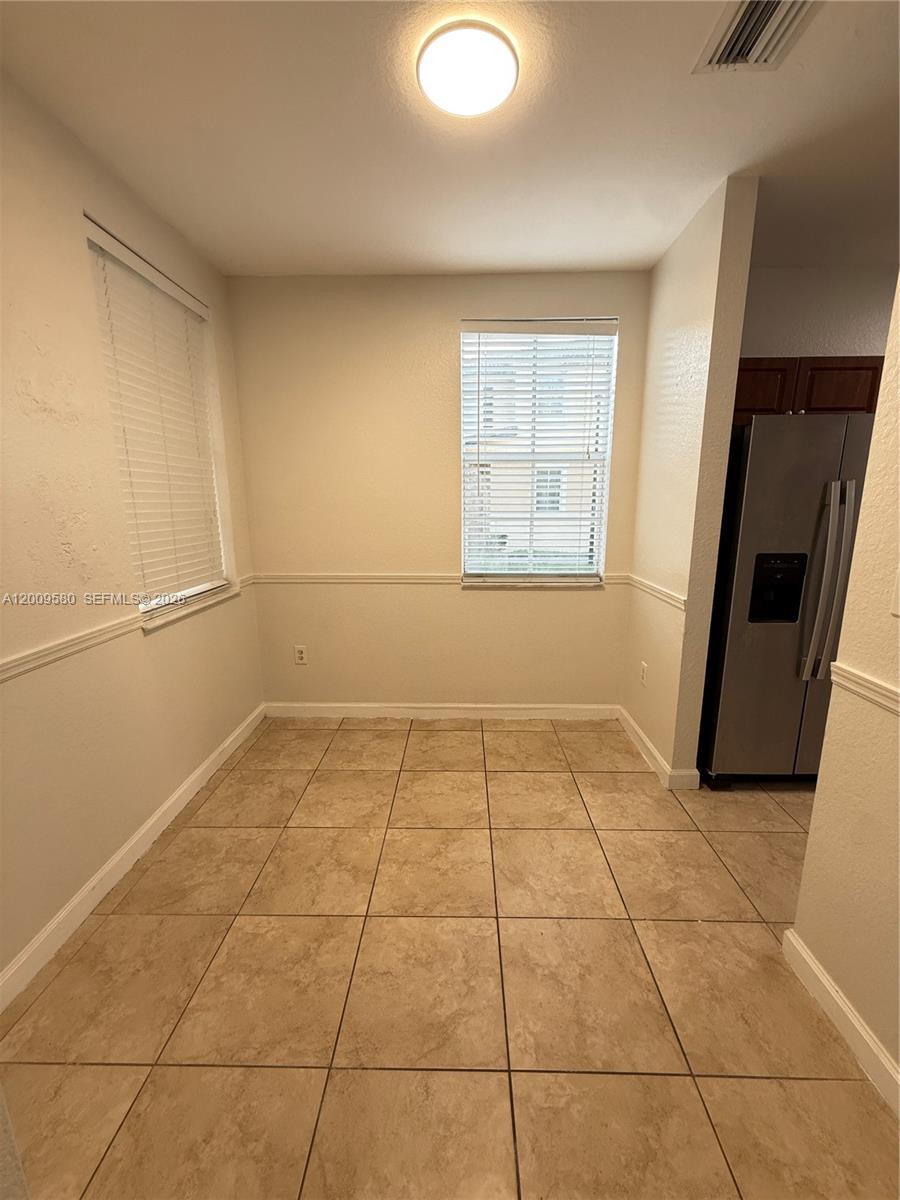 9239 Southwest 227th Street, Unit 1 Cutler Bay, FL 33190 - Photo 7 of 39 a view of a livingroom with an empty space and a window
