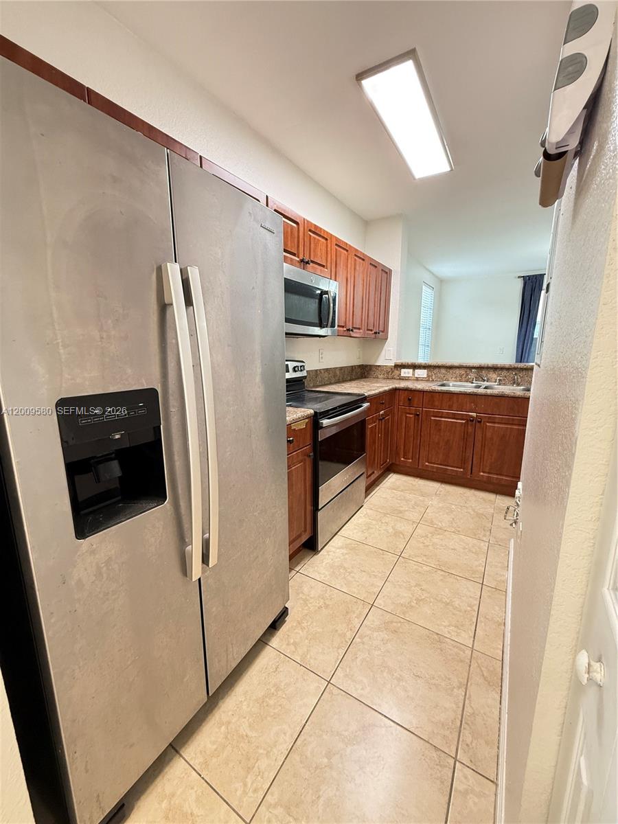 9239 Southwest 227th Street, Unit 1 Cutler Bay, FL 33190 - Photo 9 of 39 a kitchen with stainless steel appliances a refrigerator sink and stove