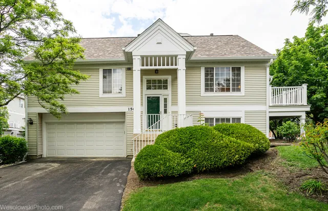 a front view of a house with a garden and plants