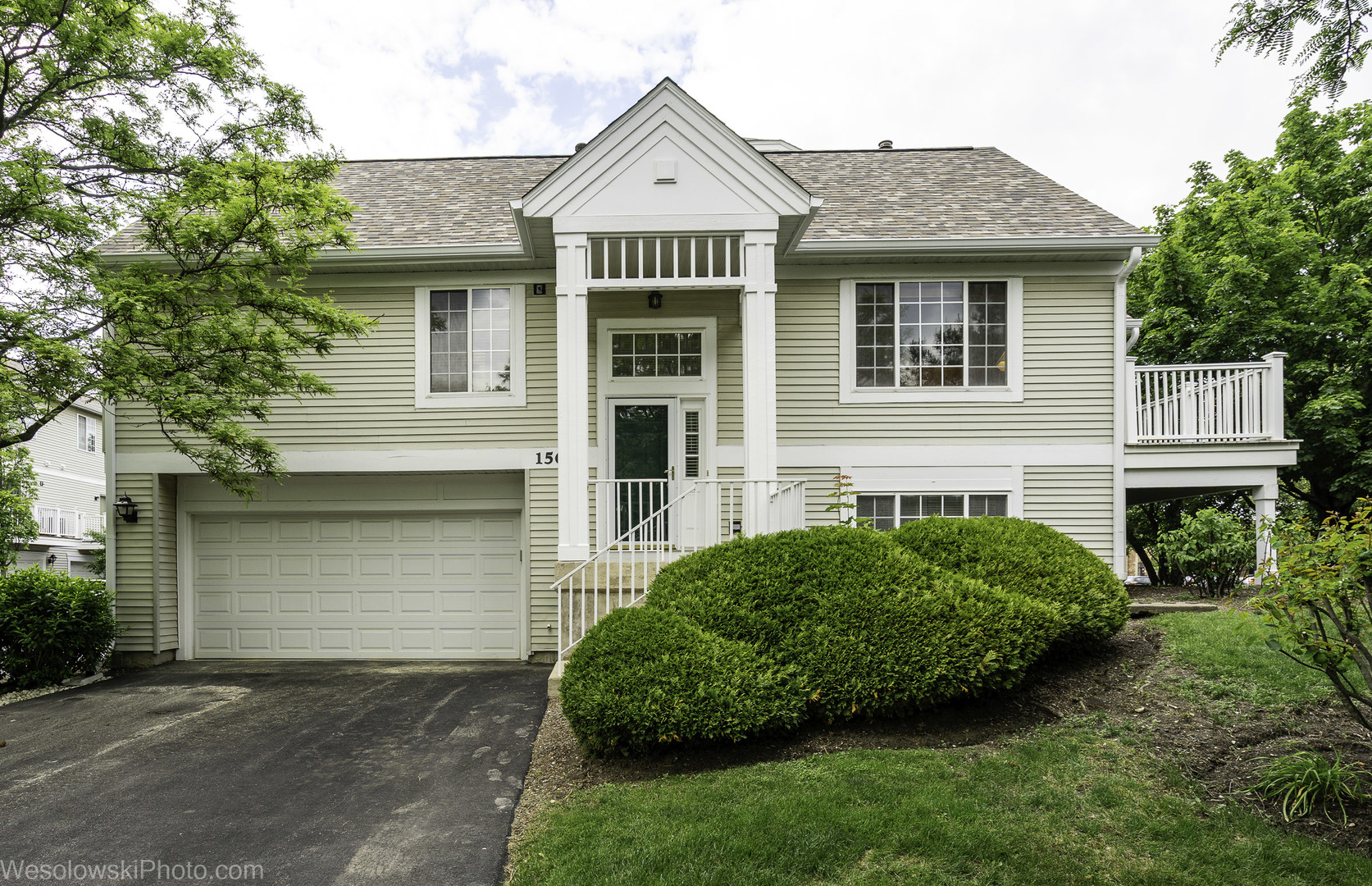 a front view of a house with a garden and plants