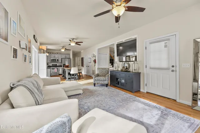 a living room with furniture and a chandelier