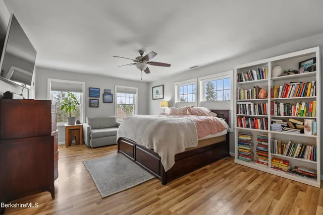 a bedroom with a bed furniture and a book shelf