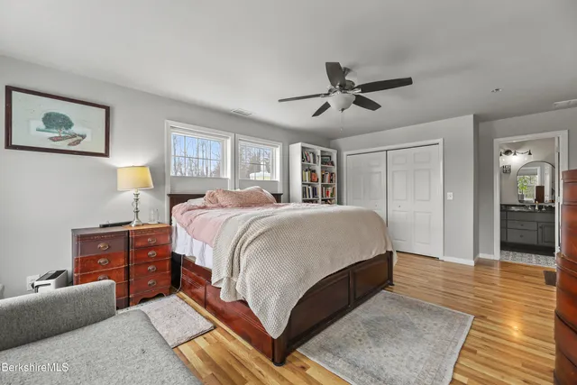 a bedroom with a large bed and a chandelier