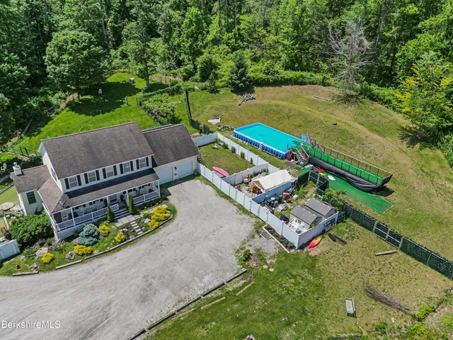 an aerial view of a house with a garden