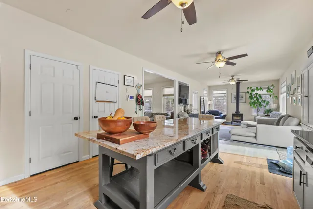 a living room with kitchen island furniture and a wooden floor