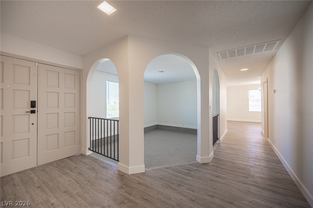 7041 North Decatur Boulevard Las Vegas, NV 89131 - Photo 15 of 33 Elegant arches and diverse flooring create a welcoming interior corridor.