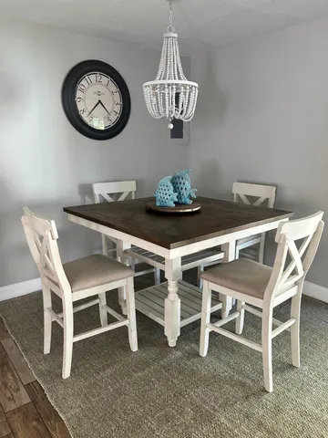 a view of a dining room that has a table and chairs