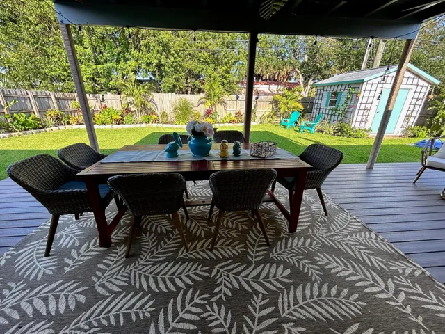 a view of a porch with furniture and garden