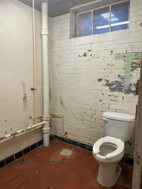 601 South Madison Avenue Monroe, GA 30655 - Photo 11 of 14 a bathroom with a toilet and a shower