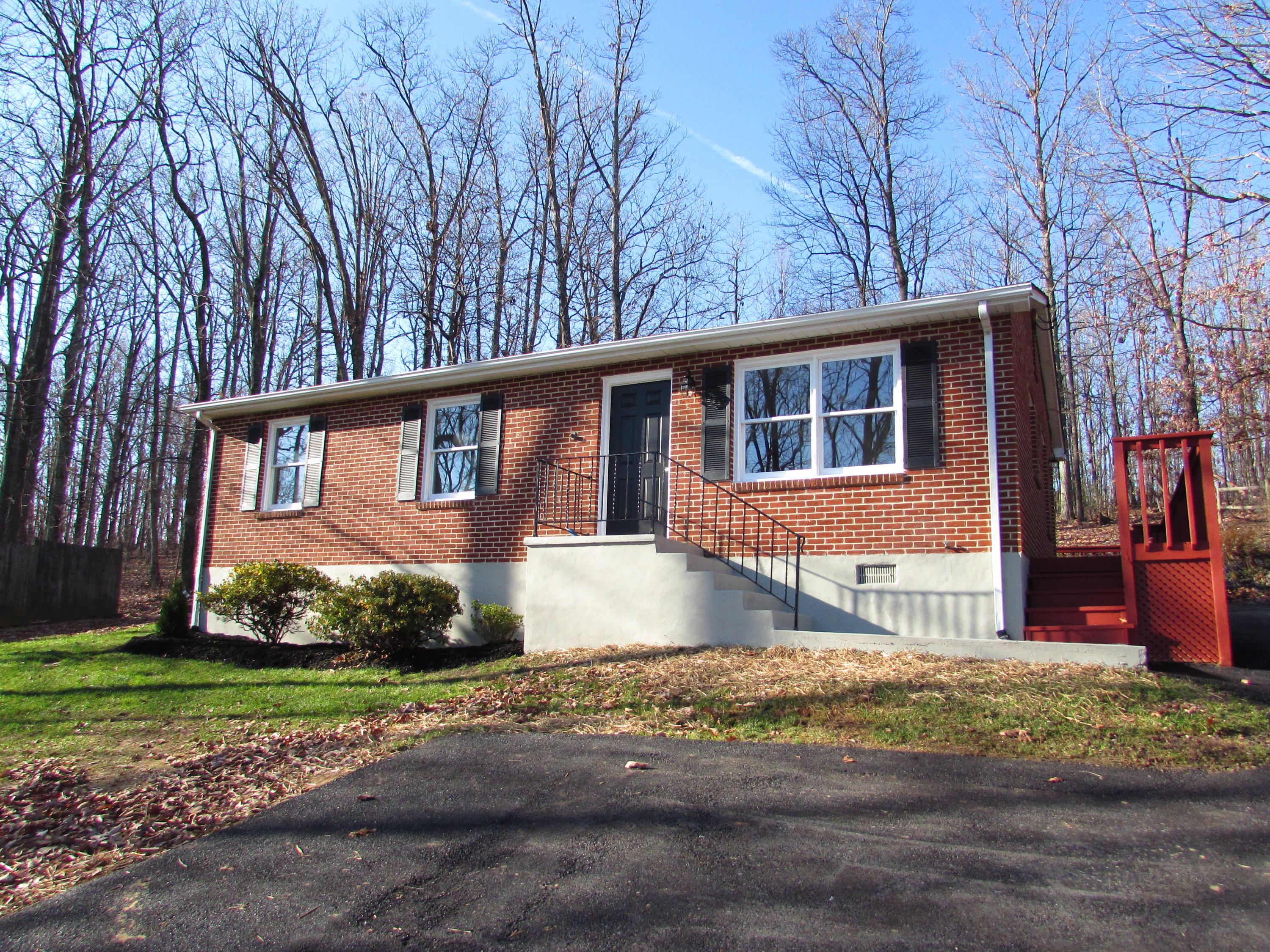819 Blue Ridge Drive Blue Ridge, VA 24064 - Photo 1 of 15 a front view of a house with a yard and garage