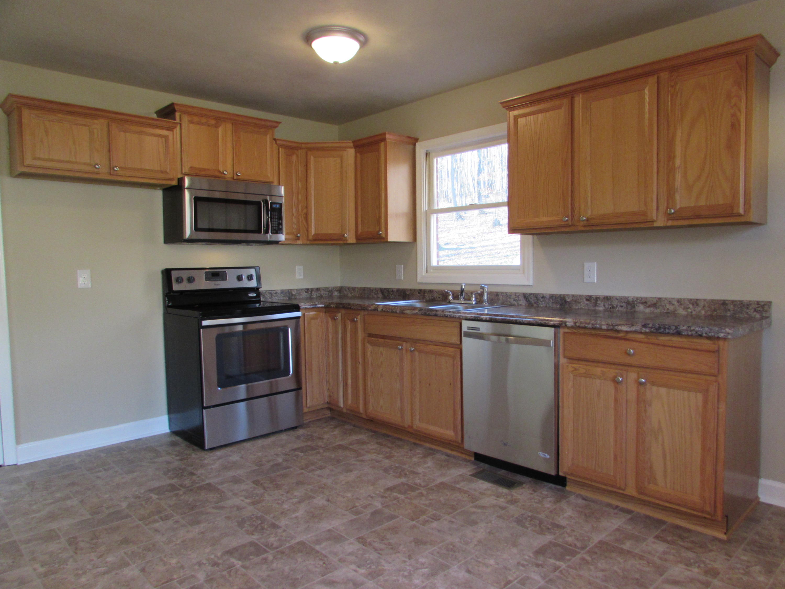 819 Blue Ridge Drive Blue Ridge, VA 24064 - Photo 3 of 15 a kitchen with stainless steel appliances granite countertop a stove a sink dishwasher and a microwave