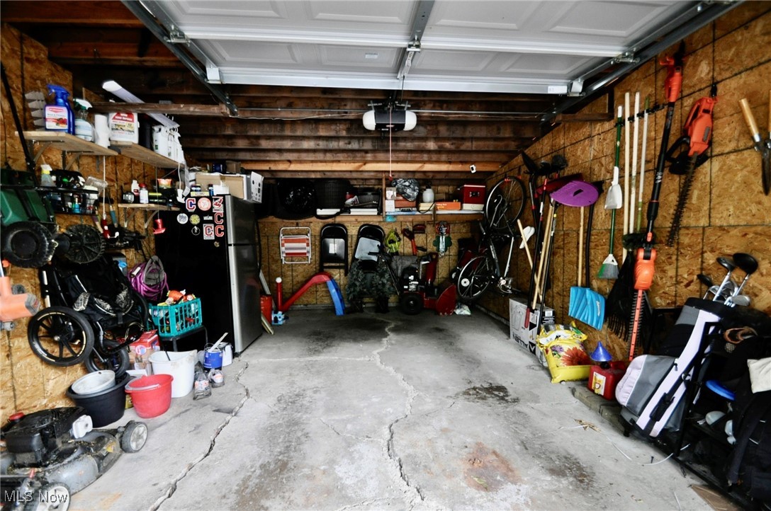 467 Cahoon Road Bay Village, OH 44140 - Photo 40 of 41 Garage with freestanding refrigerator and a garage door opener